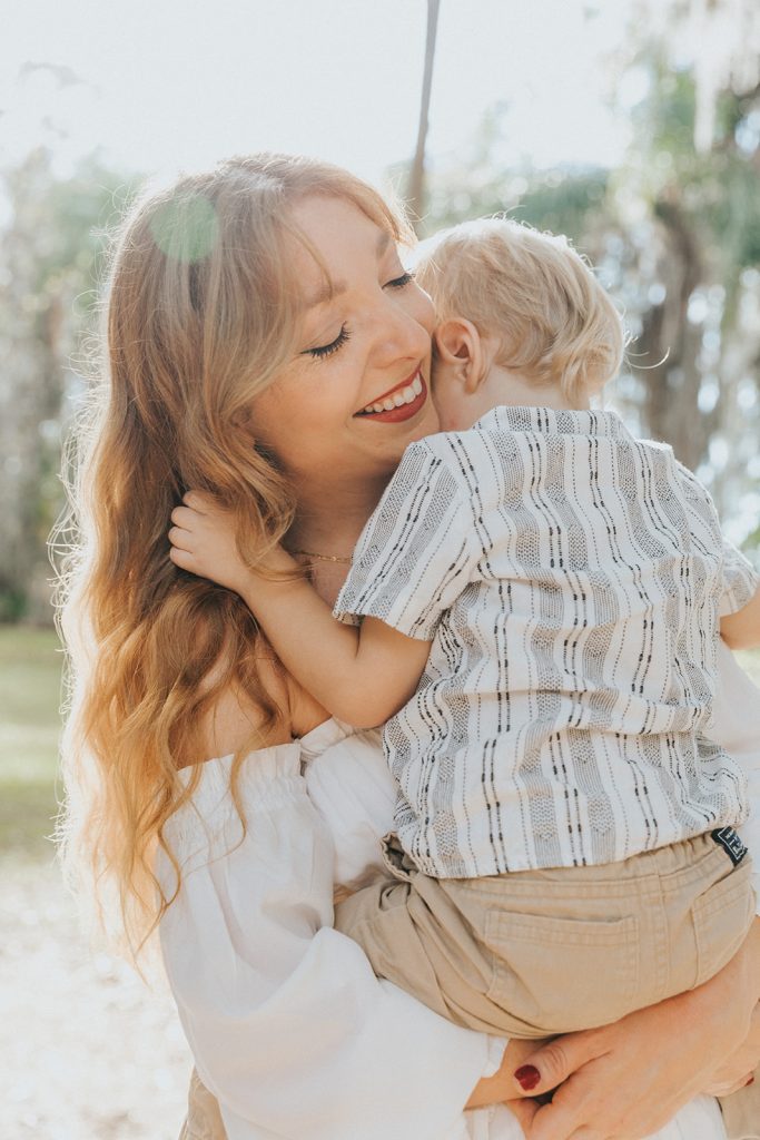 Candid mother and son photography during a beautiful outdoor family session in Winter Park, FL.
