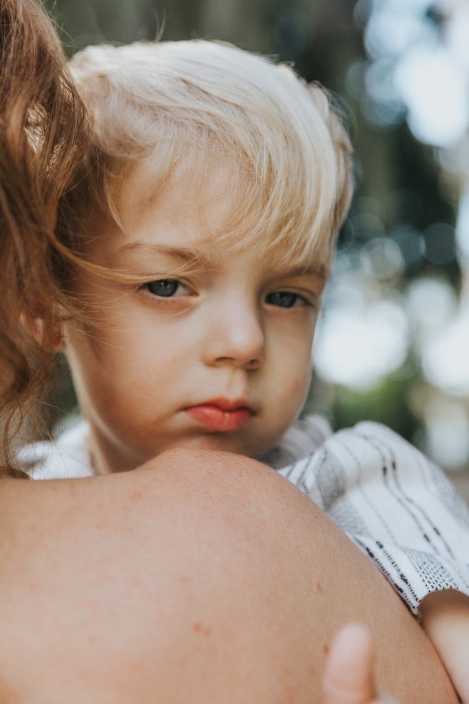 Intimate mother and son portraits with natural light at Kraft Azalea Garden in Central Florida.