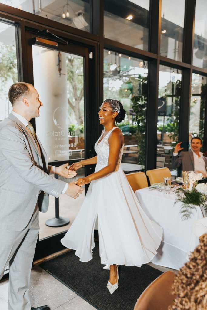 Bride and groom dancing together at The Drake Kitchen + Bar in Orlando
