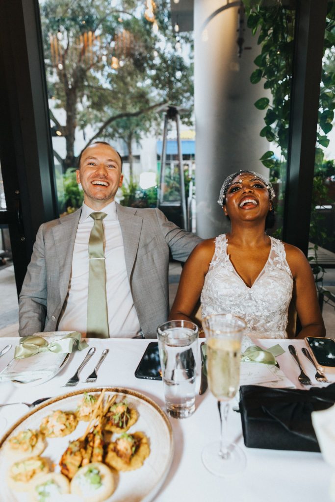 Bride and groom laughing during their intimate Orlando wedding reception